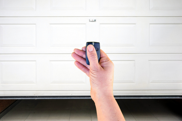 hand holding remote to the garage door