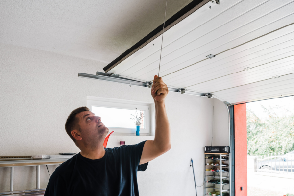 a man is manually opening the garage door